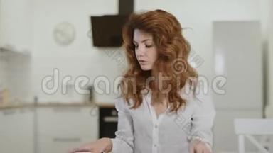 严肃的<strong>女人</strong>在开放式厨房<strong>接电话</strong>。 年轻女士在家里关闭笔记本电脑。